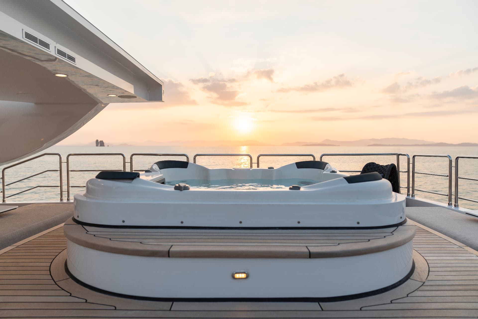 Sun deck jacuzzi at sunset aboard a Phuket superyacht charter